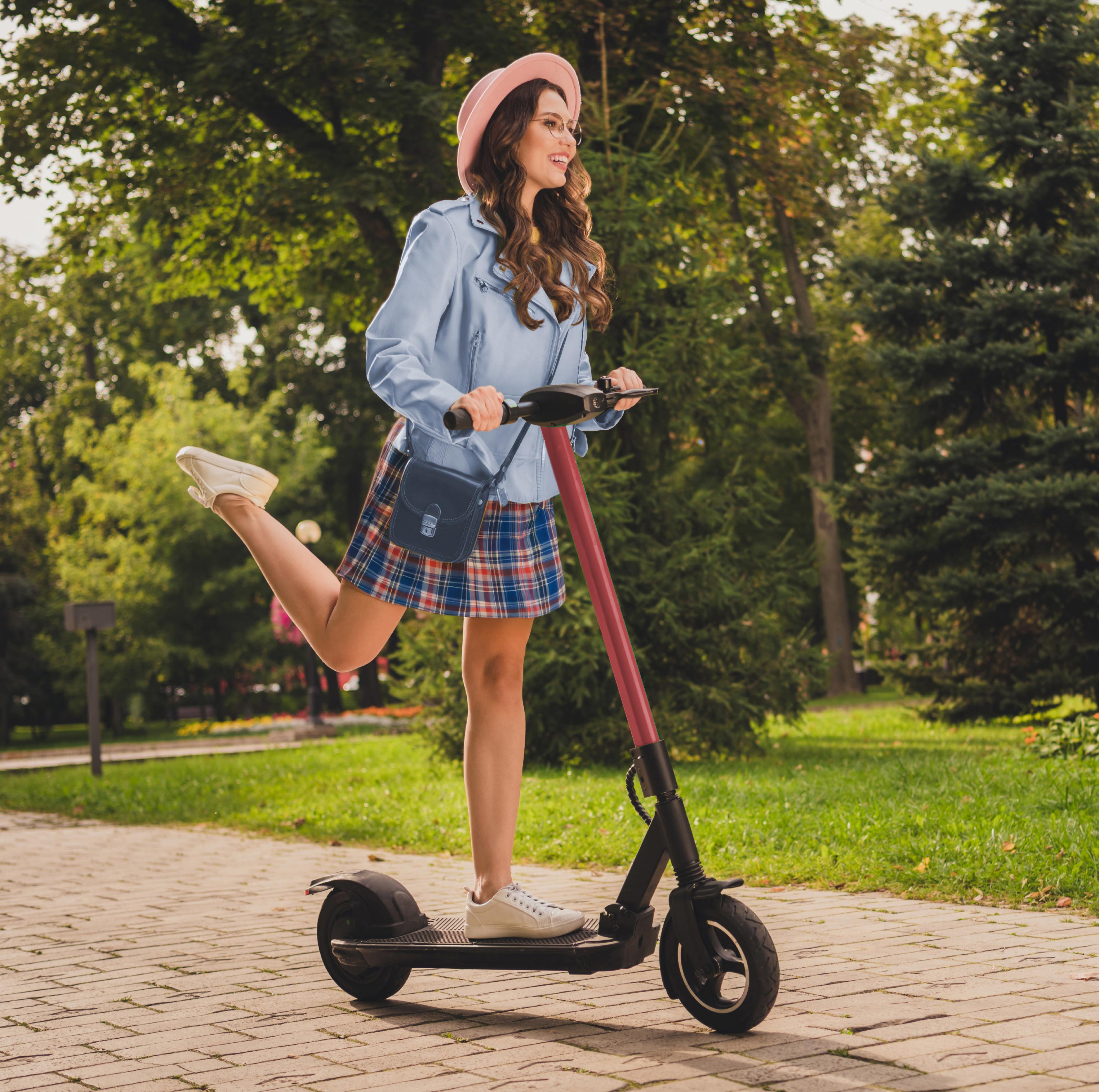 Woman riding a scooter through a park near Bolton Place